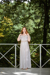 Fototapeta premium red-haired long-haired girl with freckles in nature