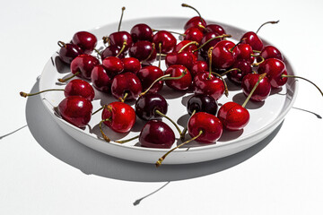 Fototapeta na wymiar Fresh seasonal red cherries in strong sunlight