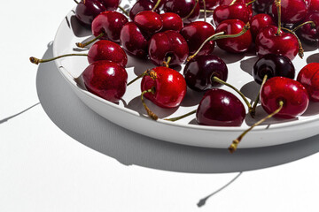Fresh seasonal red cherries in strong sunlight