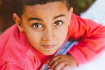 Brazilian boy smiling while doing homework