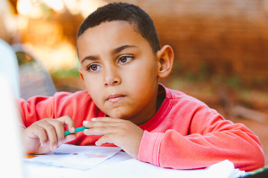 Boy doing homework outdoors