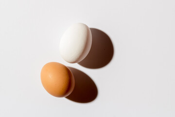 Two white eggs lie on a White background
