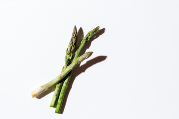 Green fresh asparagus on a gray background