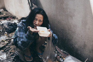 poor people,homeless or beggar begging for help sitting at dirty slum.concept for poverty...