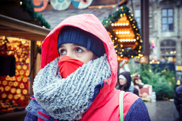 Shopping trip. A pretty young woman with a medical mask on her face. Concept of purchase of...