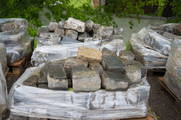 The stone is in huge packages. Selling and buying. Natural stone, construction. Paving.