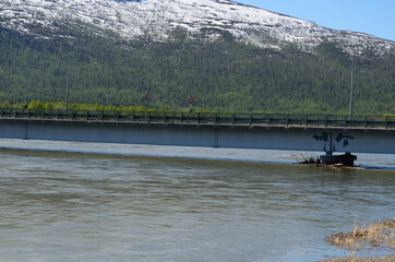 flooded river in spring underneath bridge