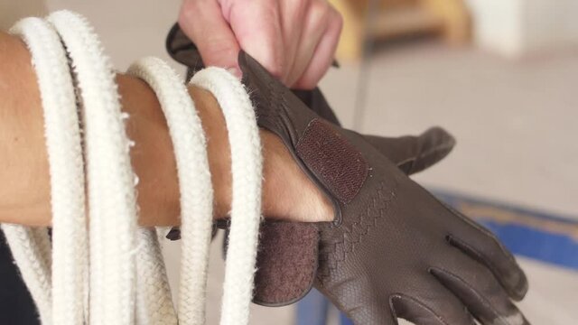 horse rider put on riding gloves slow motion