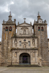 Fototapeta na wymiar Frontal view of the Cathedral of Viseu, at Easter time, with a cross hanging at the entrance