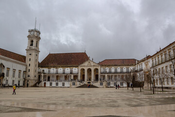 Fototapeta premium University of Coimbra and clock tower, on a day with many clouds