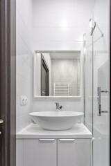 Fototapeta na wymiar Modern bathroom with white tiles, sink and mirror 0075