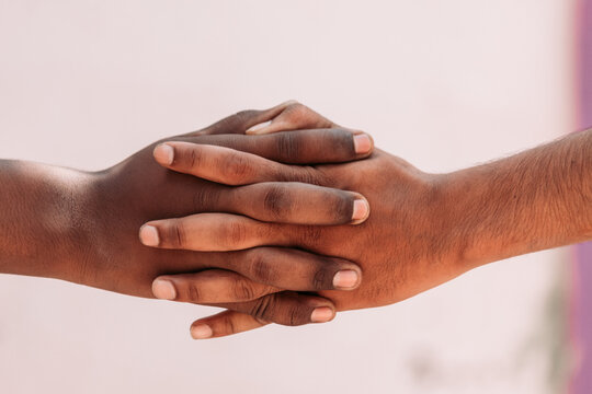 Black and white human hands in a modern handshake to show each other friendship and respect - Arm wrestling against racism