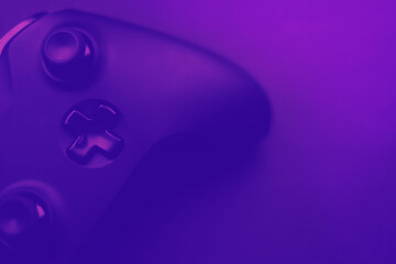 video games, esport violet blurred background with gamepad © nexusby