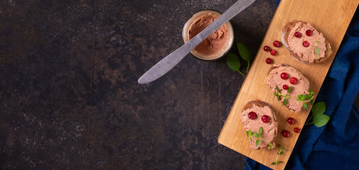 Liver pate on toast with fresh herbs and cranberries
