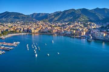 Obraz premium Panoramic aerial view of the bay of the tourist city of Rapallo, Genoa, Italy. Boat parking, resorts in Italy. Aerial photography with drone.