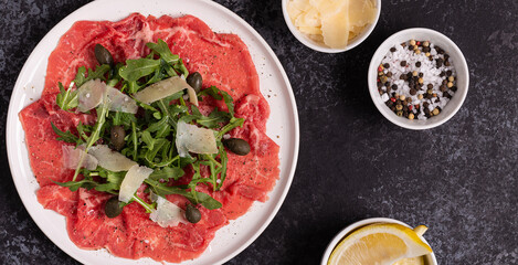 Marbled beef carpaccio with arugula, capers and parmesan cheese
