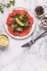 Marbled beef carpaccio with arugula, capers, lemon and parmesan cheese