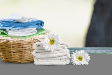 Obraz na płótnie Canvas Laundry basket with colorful towels on desk