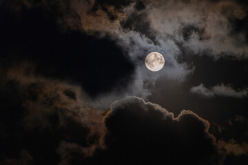 Full Moon peaking through beautiful cloudscape