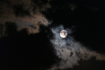 Full Moon peaking through beautiful cloudscape
