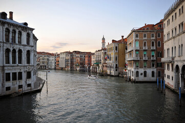 Venice channels with boats, gondolas, and colorful houses and towers