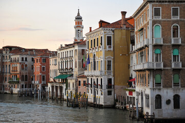 Fototapeta na wymiar Venice channels with boats, gondolas, and colorful houses and towers