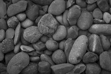 broad pile of small round  stones for background and abstract , black and white