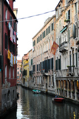 Fototapeta premium Venice channels with boats, gondolas, and colorful houses and towers