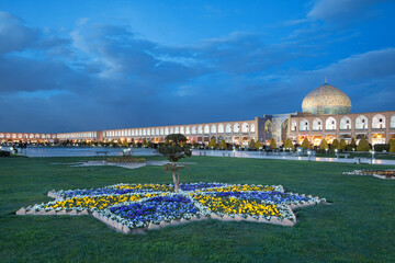 Illuminated Sheikh Lotfollah Mosque and Naqshe Jahan Square of Isfahan against Blue Sky Before Night