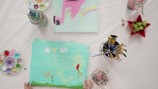 Flat lay. Little girls are painting on canvas on July 4th party.
