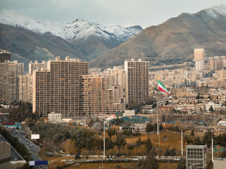 Large Iran Flag and Tehran City Skyline against Alborz Mountains with Instagram Warm Effect