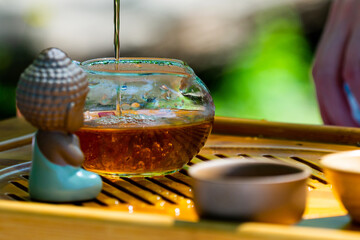 Tea ceremony. Teapot and bowls with Chinese tea on a wooden table