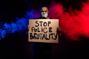 Photo of afro american guy hold paper card banner stop police brutality suffer speechless voiceless...