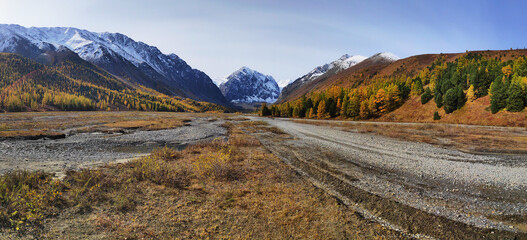 Banner autumn landscape with the Aktru river and Karatash peak. Altai mountains in clear weather...