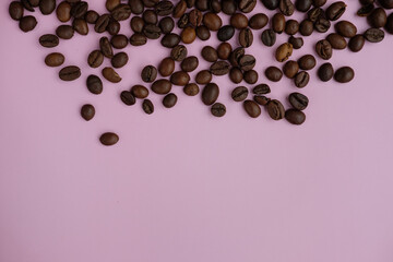 coffee beans on a pink background with empty space