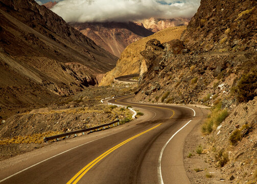 Transport. Asphalt road in the Andes mountains arid desert, on the way to Aconcagua mountai