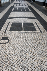 Fototapeta premium the street of praia da vitoria. details of the paved street in praia da vitoria, azores, portugal