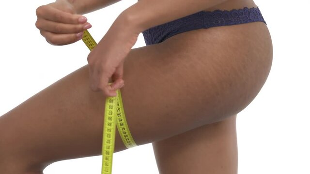 Measuring leg volume with measuring tape. Slimming, weight loss concept. Isolated on white background