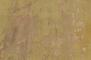 Full frame image of the yellow stucco wall with old weathered paint. Old plaster shabby surface for texture or background, design concept, copy space
