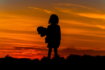 a child looks at the sunset