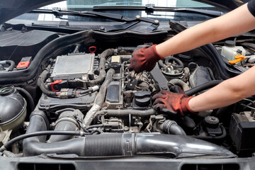 Fototapeta na wymiar Mechanic repairing car in a garage