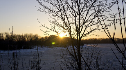 Beautiful winter sunset on the background of the river