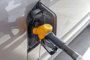 Refueling car at a gas station. Car fuel tank and diesel pump