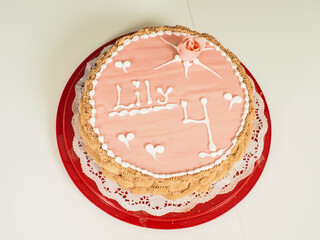 Pink marzipan covered birthday cake, with a rose and decoratet with letters Lily 4