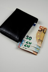 black leather wallet and euro bills
