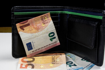 black leather wallet and euro bills