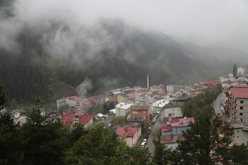Village thailand with foggy landscape mountains misty forest with tree and house in the moring winter nature / View of foggy house on hill countryside