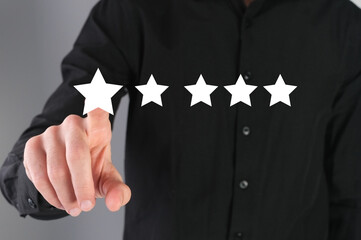 Giving a feedback, five star rate. Businessman leaves a review.