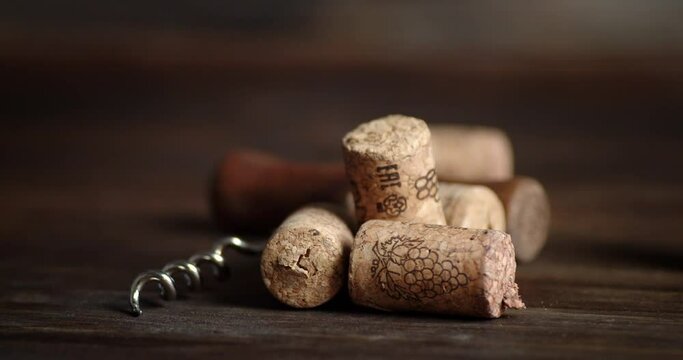 Cork from bottle of wine and a corkscrew slowly rotating.