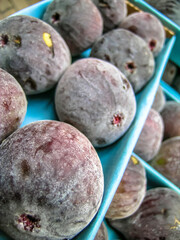 purple figs are sold at a fruit market in Brazil